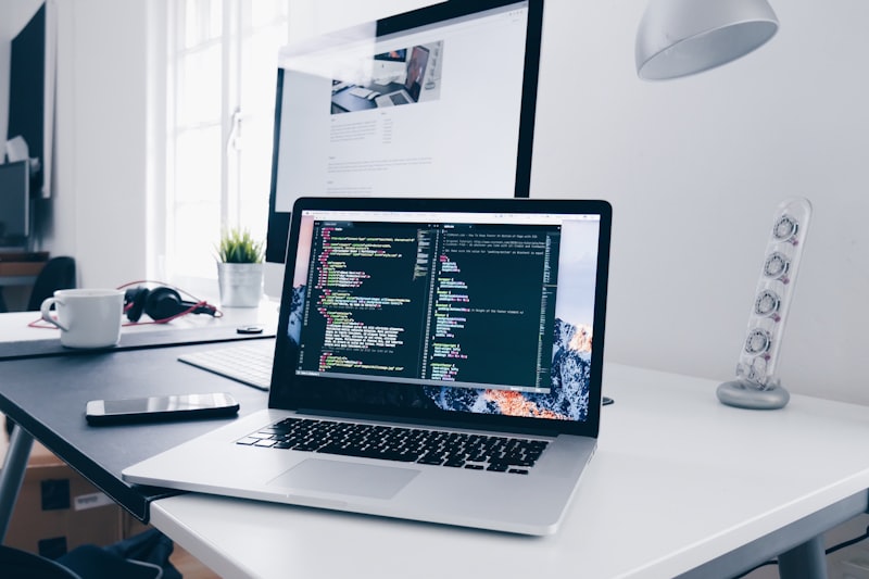 Student writing code on a laptop during DevOps training